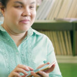 Blind person using telephone