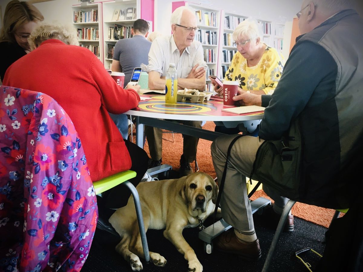 Group gather at the table for In Touch Telford tech training