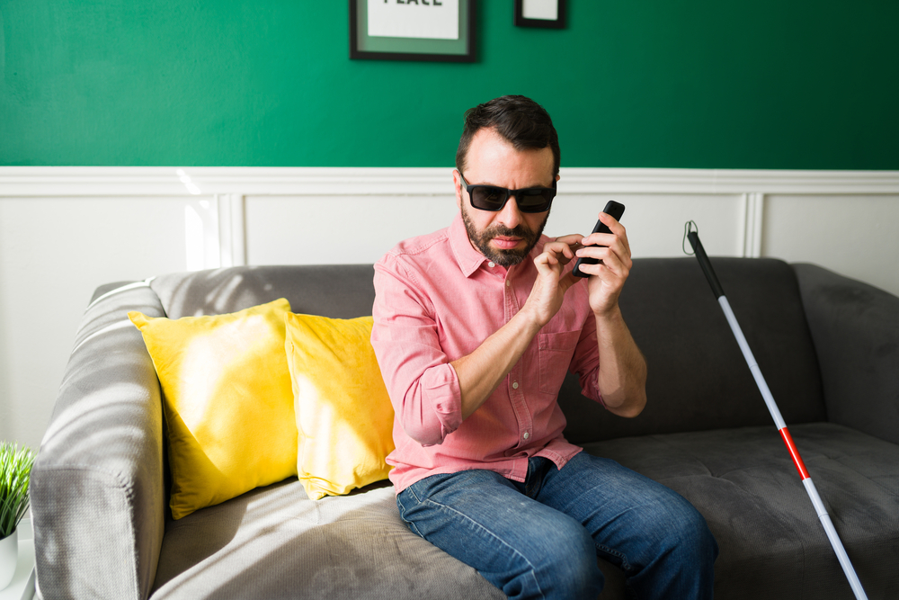 Visually impaired person texting on their smartphone.