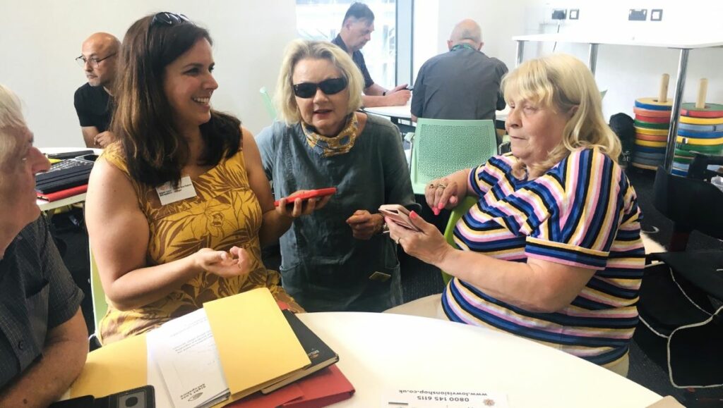 A group of people practising smartphone functions