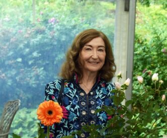 Jenny Wynn in front of a floral display