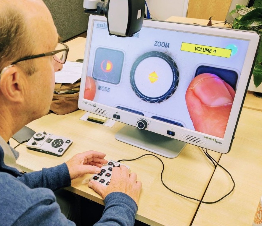 SLS Equipment Rehoming Volunteer testing a video magnifier