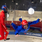 Person taking part in indoor skydiving with an instructor. Image courtesy of iFly.