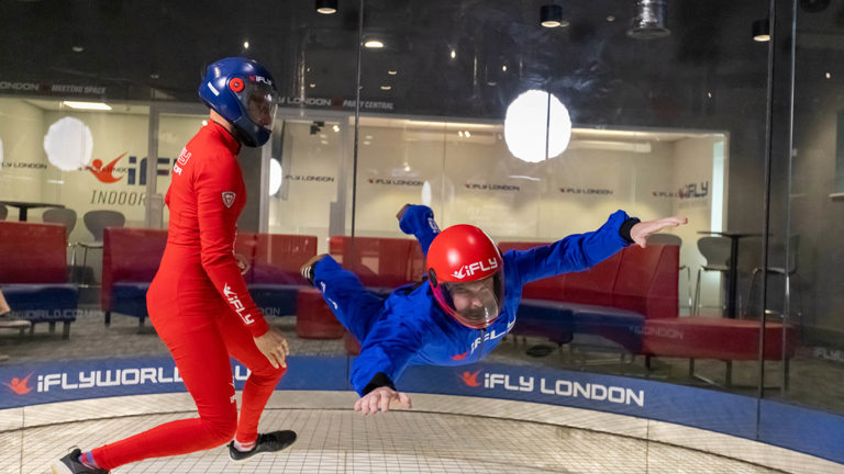Person taking part in indoor skydiving with an instructor. Image courtesy of iFly.