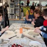 Young people with aight loss enjoying a pottery activity