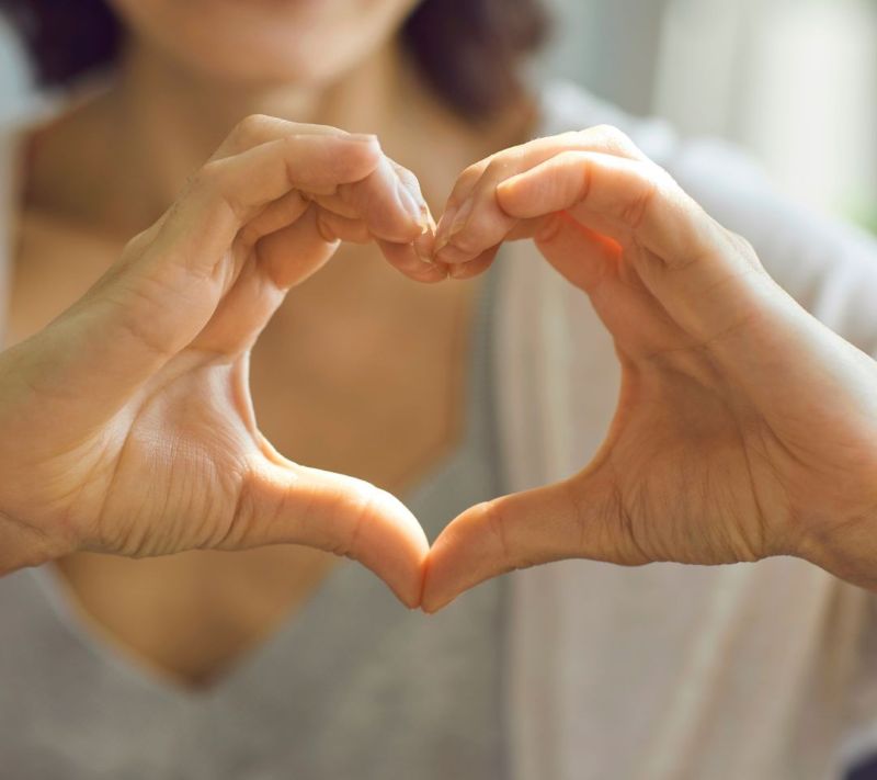 Hands held in the shape of a heart