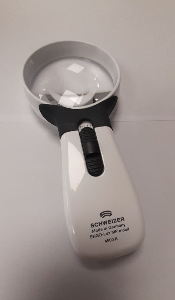 Hand held magnifier with LED light