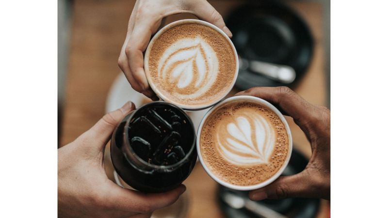 Hands holding coffee and drinks