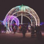 People walking through large illuminated bauble at Blackpool Illuminations