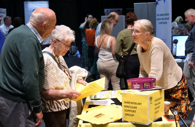Exhibitors and visitors at See Hear Remember exhibition