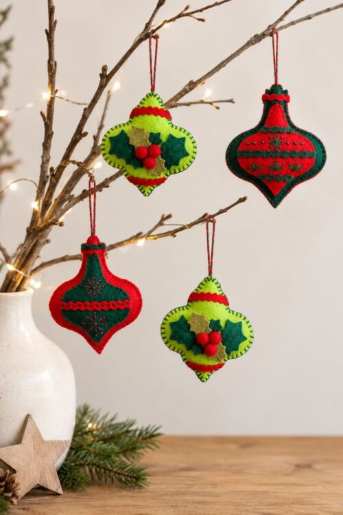 Handmade felt decorations on twigs, with hand-stitched embroidery or delicate holly details in red and green.