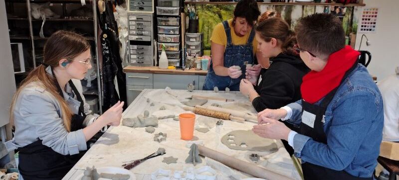 Young people with aight loss enjoying a pottery activity