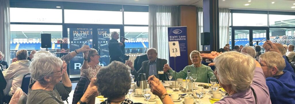 Guests enjoying the party at Sight Loss Shropshire's Spring Day Out whilst singer Tony Wall entertains