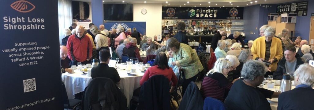 A large group of people seated around tables and chatting at a Winters Day Out