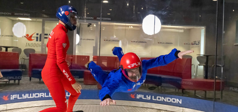 Person taking part in indoor skydiving with an instructor. Image courtesy of iFly.